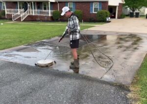 Pressure wash asphalt driveway before sealing