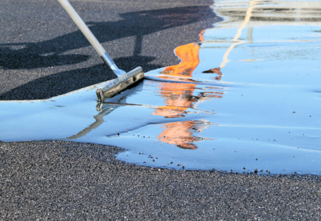 Pressure wash asphalt driveway before sealing