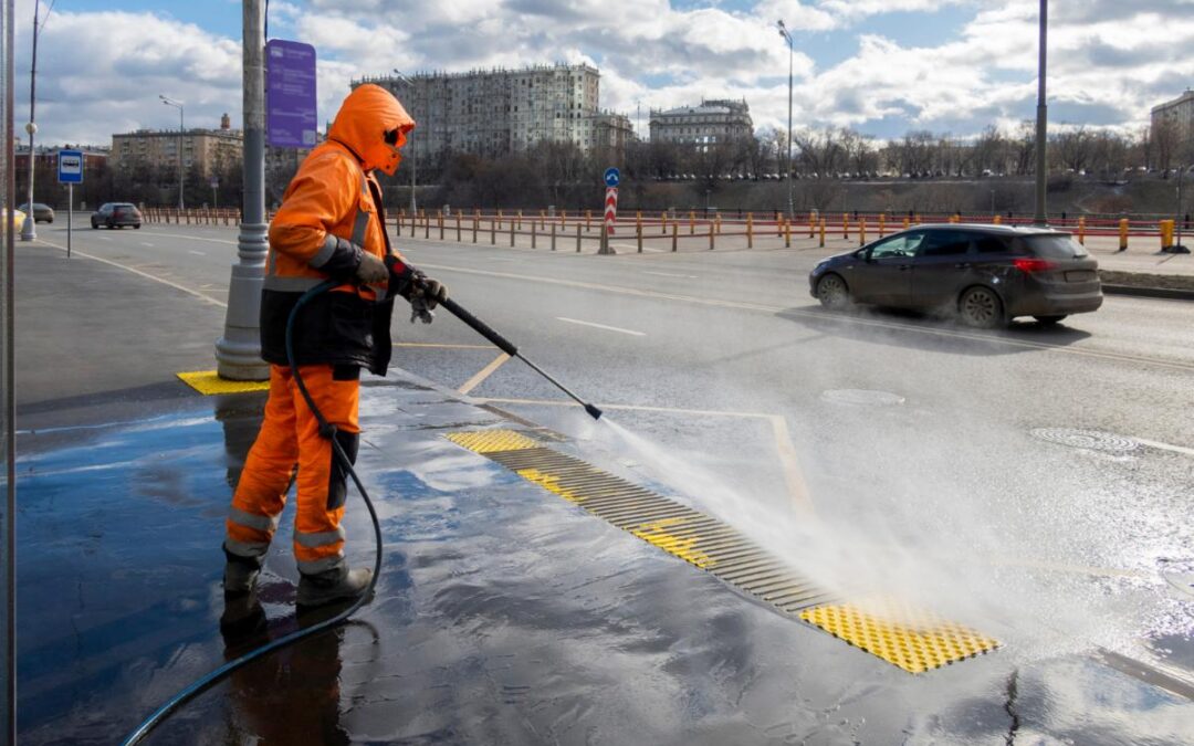 Pressure washing an asphalt driveway