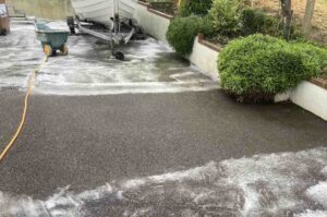 Pressure wash asphalt driveway before sealing