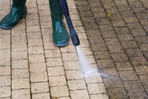 Pressure washing dirty driveway